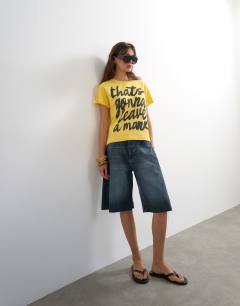 Model wearing Topshop 'That's Gonna Leave A Mark' graphic tee in yellow
