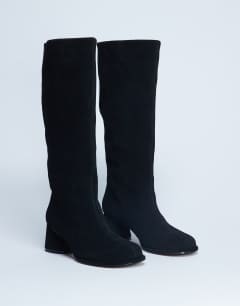 Model wearing Thea real suede knee high block heel boot in black