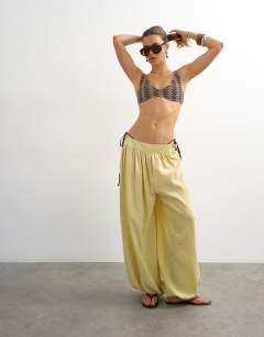 Model wearing Thea scoop bikini top in chocolate