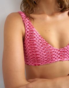 Model wearing Thea scoop bikini top in pink