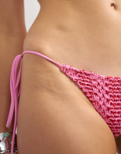 Model wearing Thea thong bikini bottom in pink