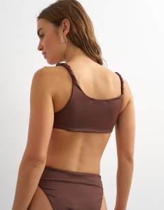 Model wearing Tiana bandeau bikini top with twisted strap in chocolate
