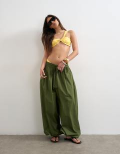 Model wearing Tiana bandeau bikini top with twisted strap in yellow