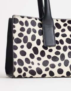 Model wearing Tiana hair on real leather bowler tote bag in dalmatian print