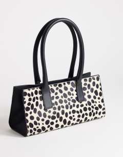 Model wearing Tiana hair on real leather bowler tote bag in dalmatian print