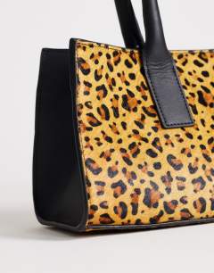 Model wearing Tiana hair on real leather bowler tote bag in leopard print
