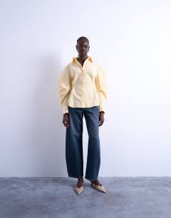 Model wearing Tie back waist long sleeve shirt in buttermilk