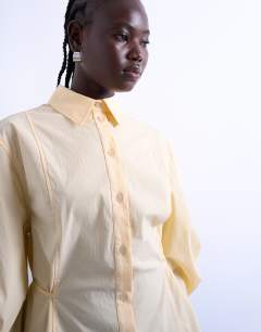 Model wearing Tie back waist long sleeve shirt in buttermilk