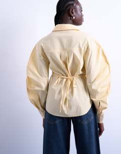 Model wearing Tie back waist long sleeve shirt in buttermilk
