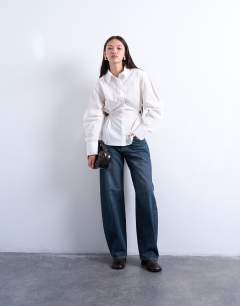 Model wearing Tie back waist long sleeve shirt in ivory