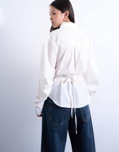 Model wearing Tie back waist long sleeve shirt in ivory
