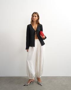 Model wearing Tie detail blouse in black