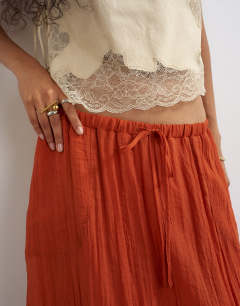 Model wearing Tie detail crinkle bubble hem maxi skirt in rust