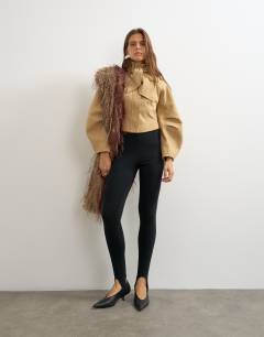 Model wearing Tie neck fitted ovoid sleeve jacket in beige