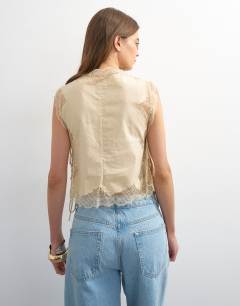 Model wearing Tie side lace detail top in ecru