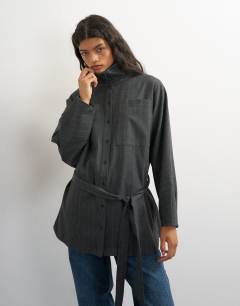 Model wearing Tie waist funnel neck shirt in grey pinstripe