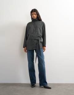 Model wearing Tie waist funnel neck shirt in grey pinstripe