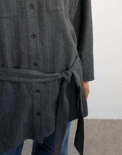Model wearing Tie waist funnel neck shirt in grey pinstripe
