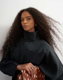 Model wearing Tie waist funnel neck tunic top in black