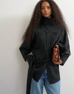 Model wearing Tie waist funnel neck tunic top in black