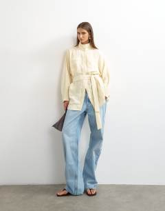 Model wearing Tie waist funnel neck tunic top in buttermilk