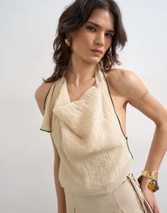 Model wearing Tie waist halter neck maxi dress with contrast trim in ecru