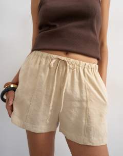 Model wearing Tie waist seam detail shorts in stone
