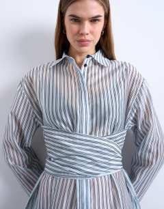 Model wearing Tie waisted sheer shirt in blue stripe