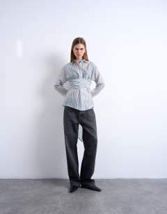 Model wearing Tie waisted sheer shirt in blue stripe