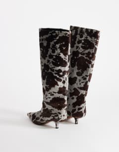 Model wearing Tina hair on real leather kitten heel knee boot in grey leopard