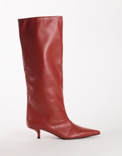 Model wearing Tina real leather kitten heel knee boot in red