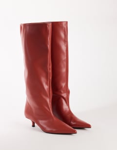 Model wearing Tina real leather kitten heel knee boot in red