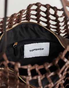 Model wearing Tobias large woven tote bag in chocolate