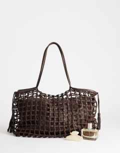 Model wearing Tobias woven tote bag in chocolate