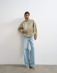 Model wearing Toggle waist leather look zip through jacket in taupe