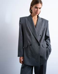 Model wearing Tonic 80s double breasted oversized suit blazer in grey