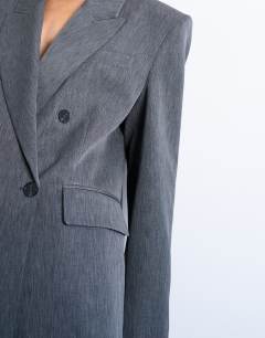 Model wearing Tonic 80s double breasted oversized suit blazer in grey