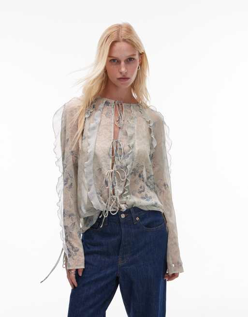 Topshop - Top trasparente allacciato sul davanti con stampa effetto pizzo a fiori e volant