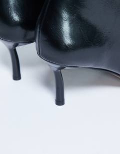 Model wearing Tori knee high point toe boot in black