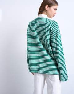 Model wearing Towelling stripe long sleeve polo in green