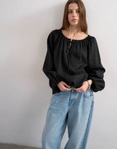 Model wearing Trapeze linen tie front blouse in black