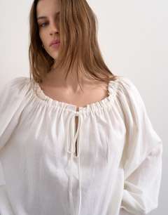 Model wearing Trapeze linen tie front blouse in white