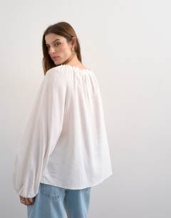 Model wearing Trapeze linen tie front blouse in white