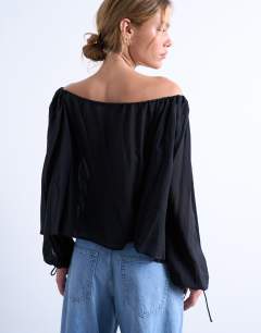Model wearing Trapeze long sleeve tie detail blouse in  black