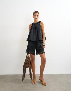 Model wearing Trapeze tie back top in black