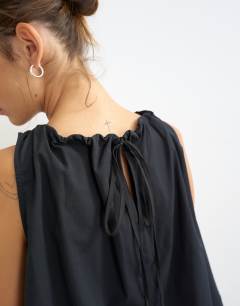 Model wearing Trapeze tie back top in black
