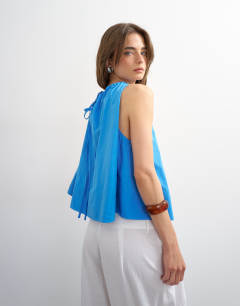 Model wearing Trapeze tie back top in blue