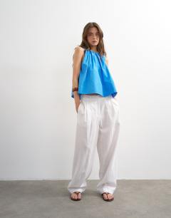 Model wearing Trapeze tie back top in blue