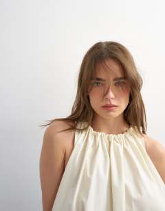 Model wearing Trapeze tie back top in ecru