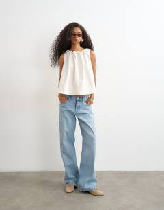 Model wearing Trapeze tie back top in ecru